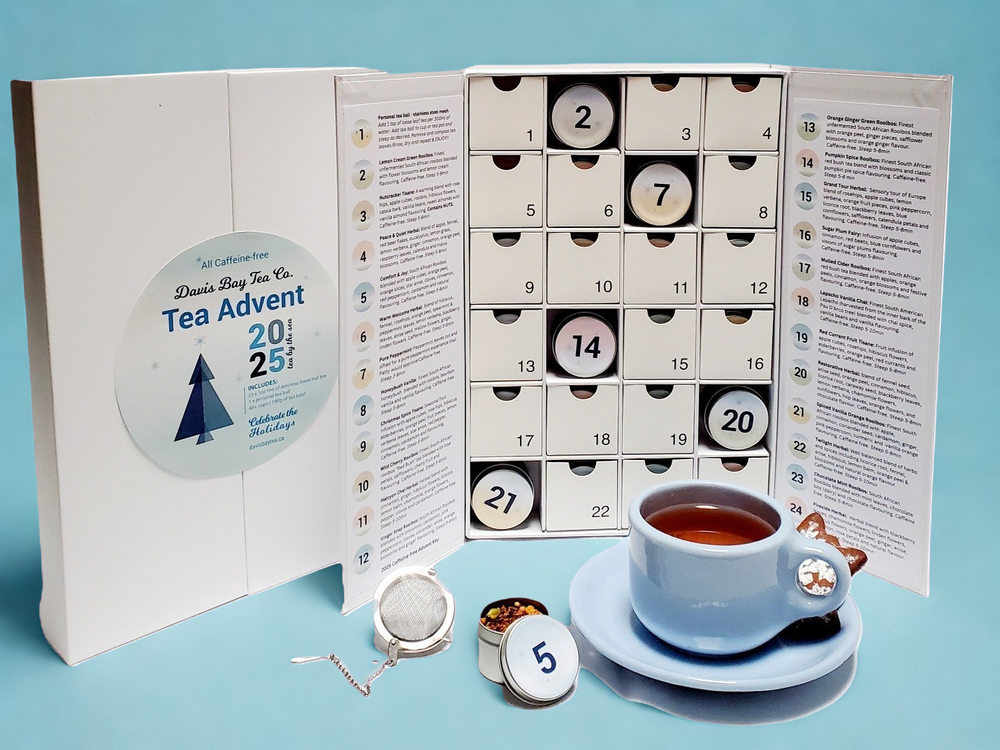 tea advent calendar with tea tins and tea cup with freshly steeped tea and tea accessories