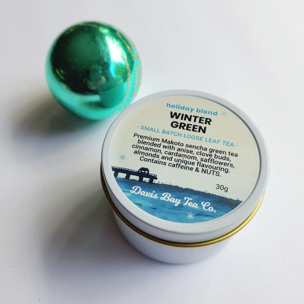 
                  
                    White tin of 'Winter Green' tea with a label on a white background
                  
                