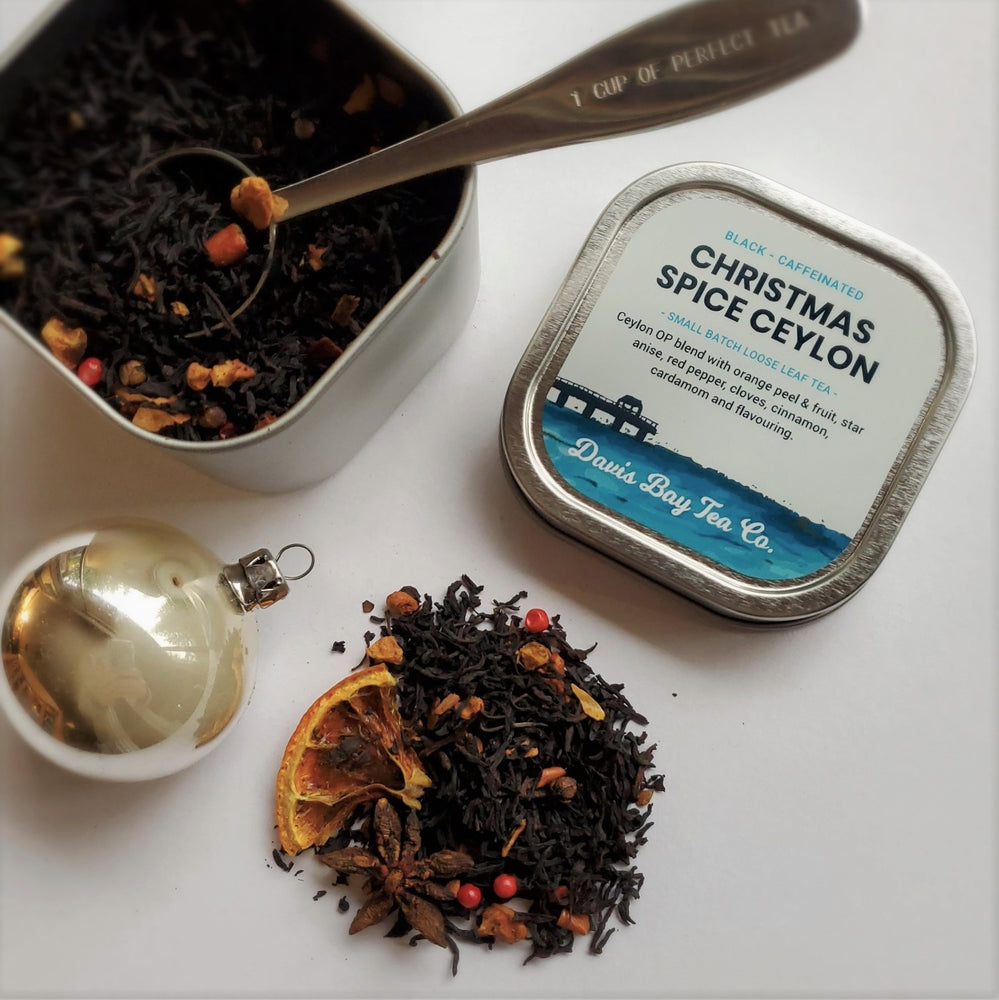 open tin of Christmas Spice Ceylon tea and pile of tea next to lid