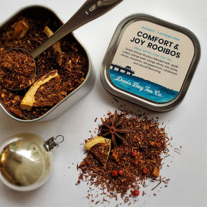 
                  
                    open tin of Comfort & Joy tea with scoop in tea tin and tea on display
                  
                